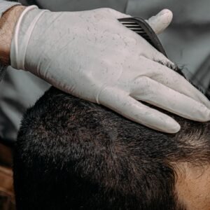 a close up of a person cutting another persons hair